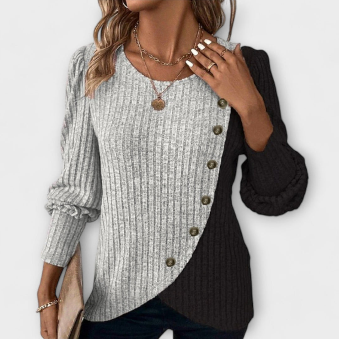 Women’s knitted blouse with colorblock detailing and asymmetric buttons, suitable for office outfits, casual wear, and everyday styling.