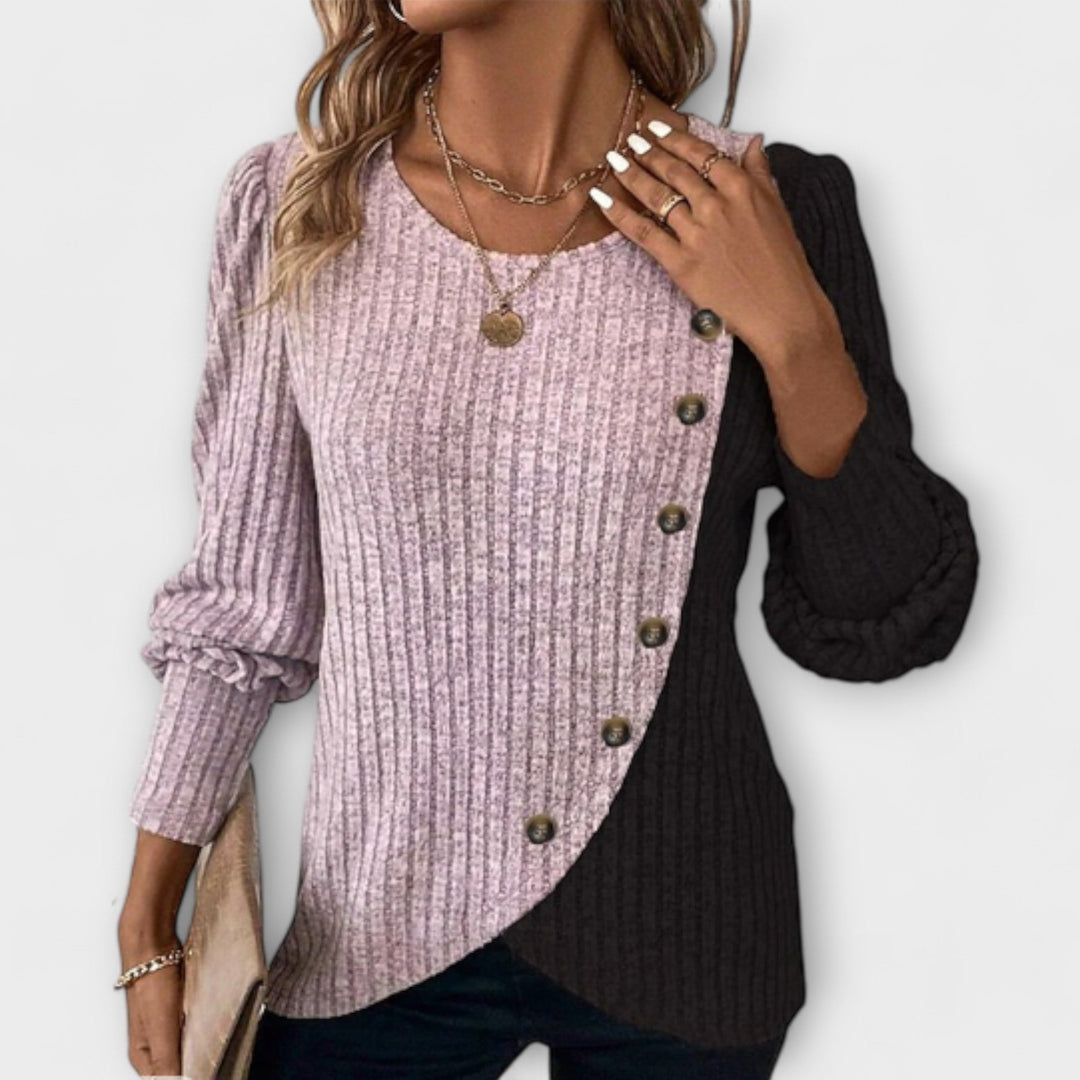 Women’s knitted blouse with colorblock detailing and asymmetric buttons, suitable for office outfits, casual wear, and everyday styling.