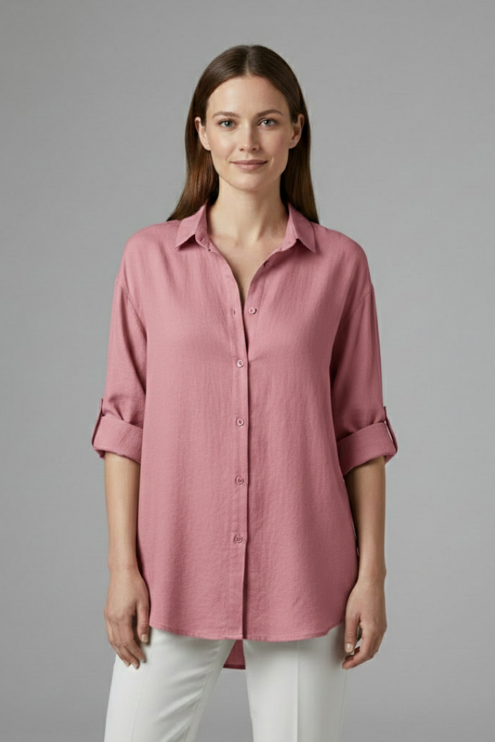 Women’s long blouse with button fastening and chest pockets, featuring a collared neckline and rounded hem for everyday and work styling.