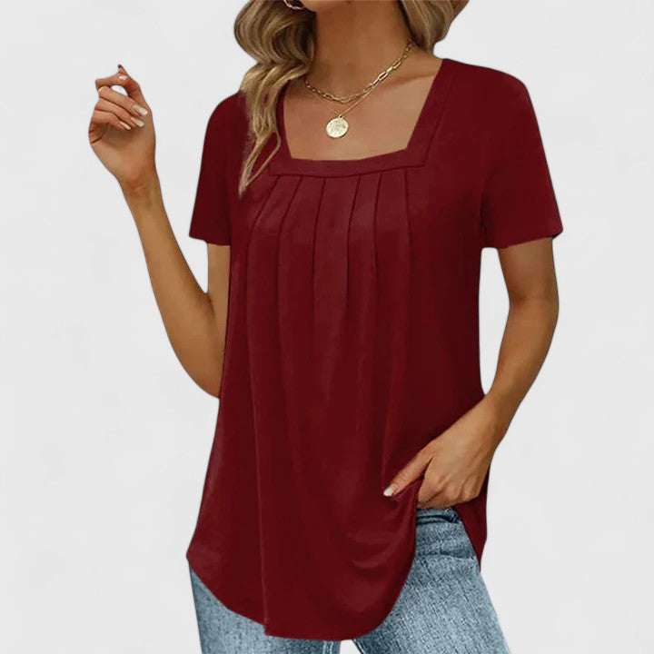 Women’s pleated blouse with a square neckline and relaxed fit, ideal for summer outfits, office wear, and smart casual occasions.