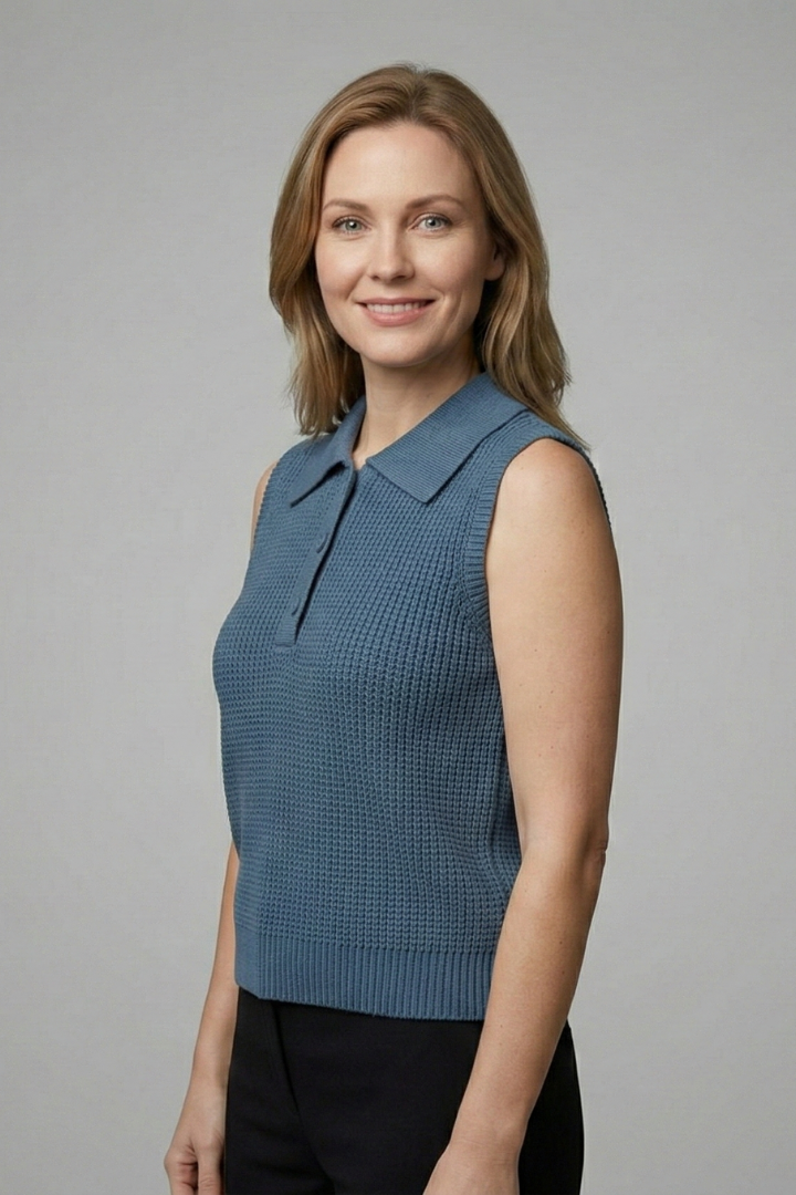 Women’s sleeveless polo top with button placket, wide shoulders, and textured finish, suitable for office wear and casual outfits.