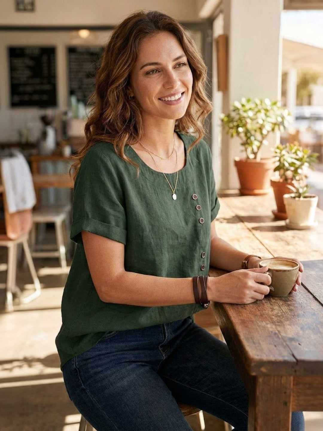 Women’s round neck blouse with button detailing and a relaxed fit, suitable for summer outfits, casual wear, and everyday styling.