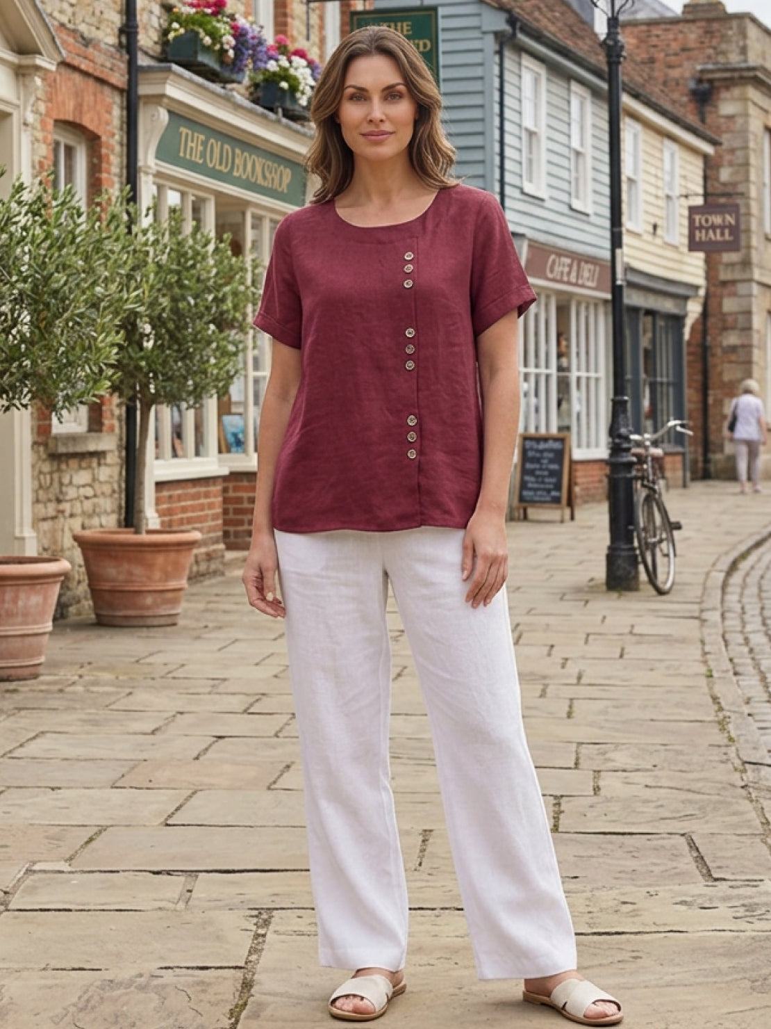 Women’s round neck blouse with button detailing and a relaxed fit, suitable for summer outfits, casual wear, and everyday styling.
