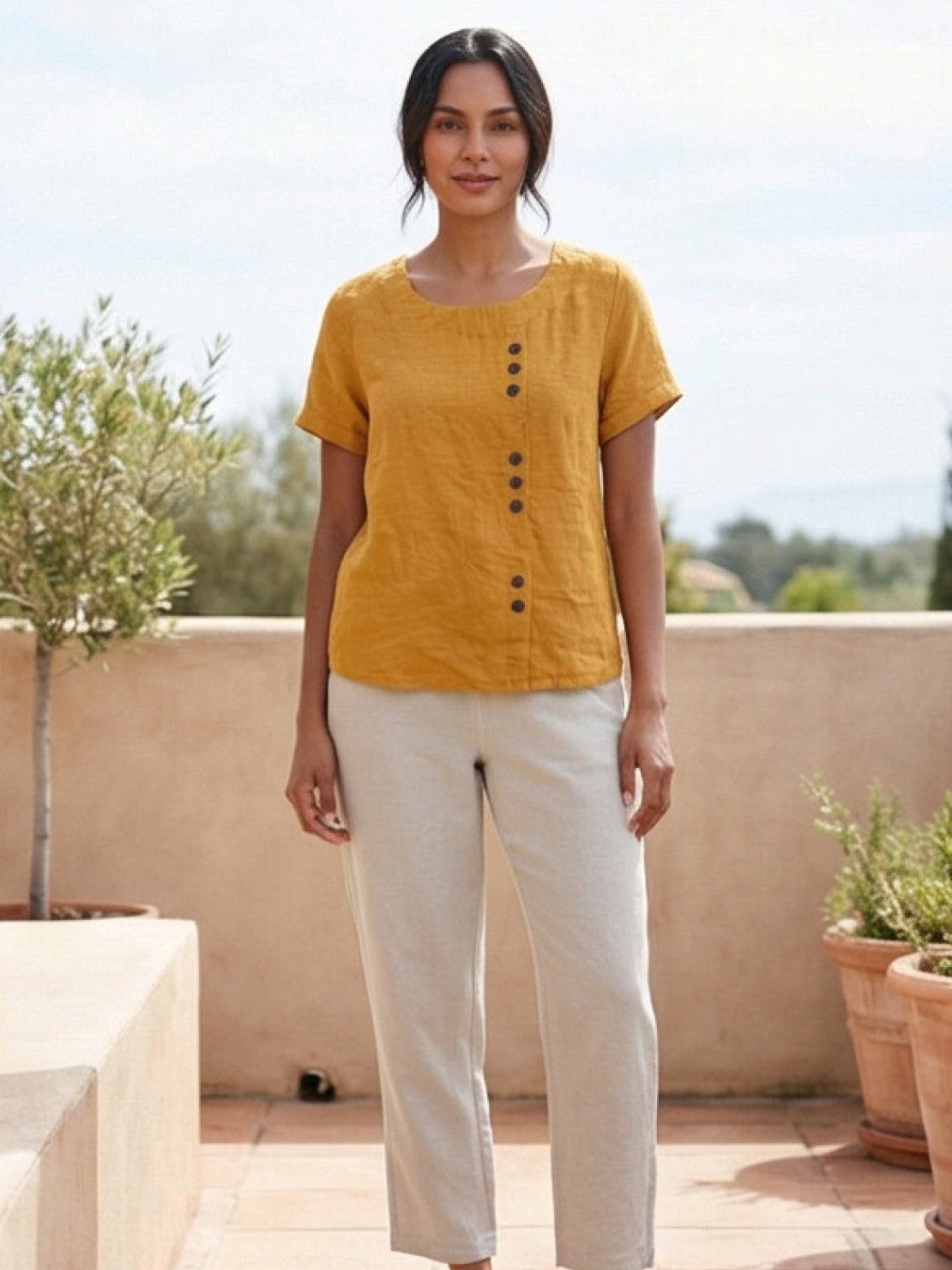 Women’s round neck blouse with button detailing and a relaxed fit, suitable for summer outfits, casual wear, and everyday styling.