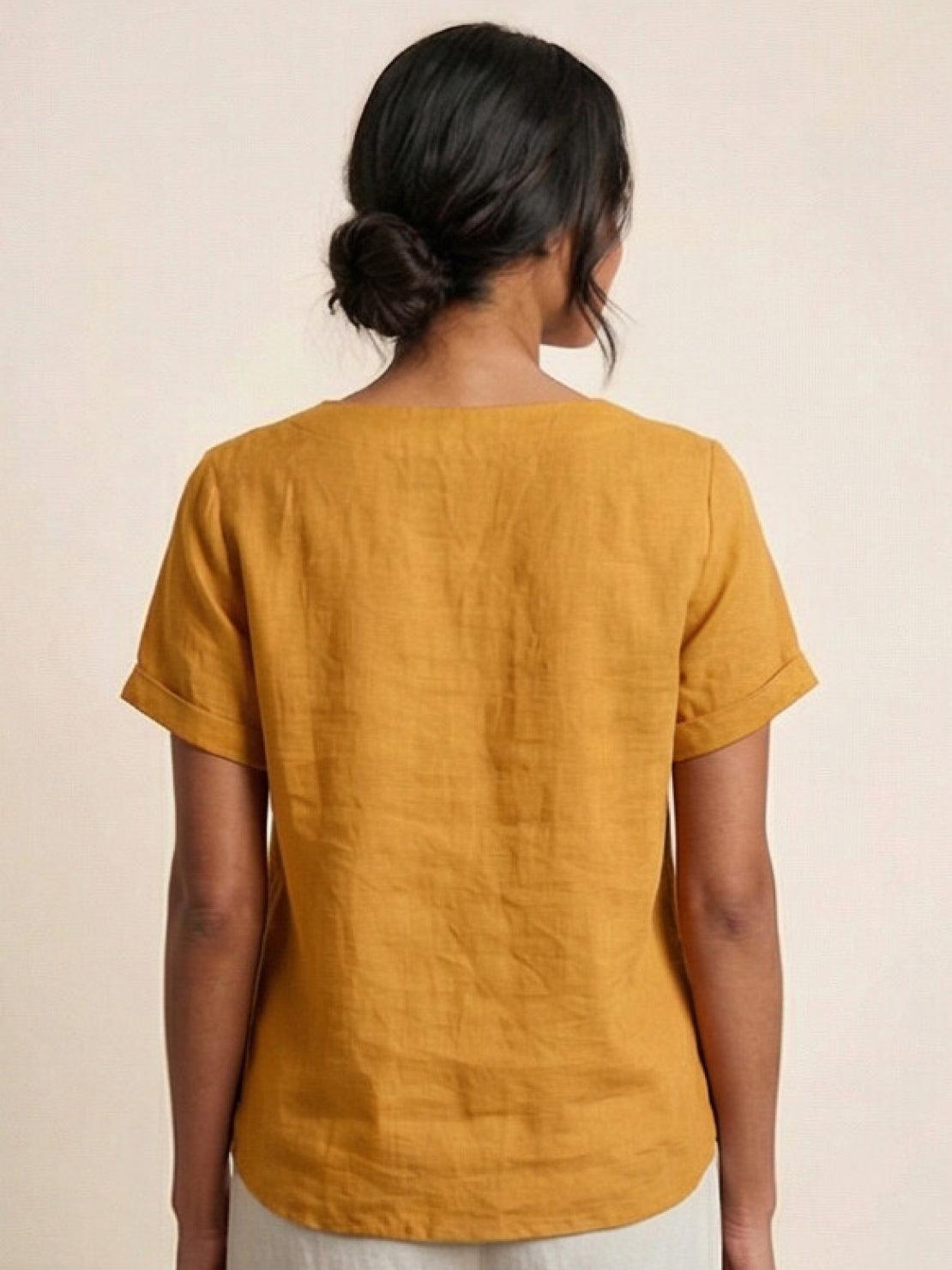 Women’s round neck blouse with button detailing and a relaxed fit, suitable for summer outfits, casual wear, and everyday styling.