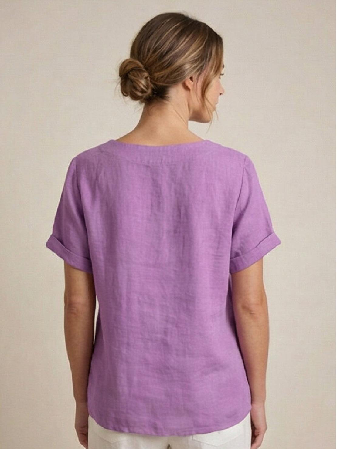 Women’s round neck blouse with button detailing and a relaxed fit, suitable for summer outfits, casual wear, and everyday styling.