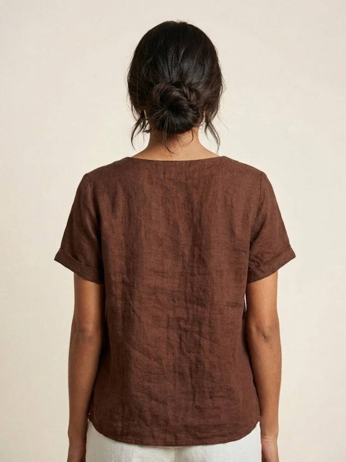 Women’s round neck blouse with button detailing and a relaxed fit, suitable for summer outfits, casual wear, and everyday styling.