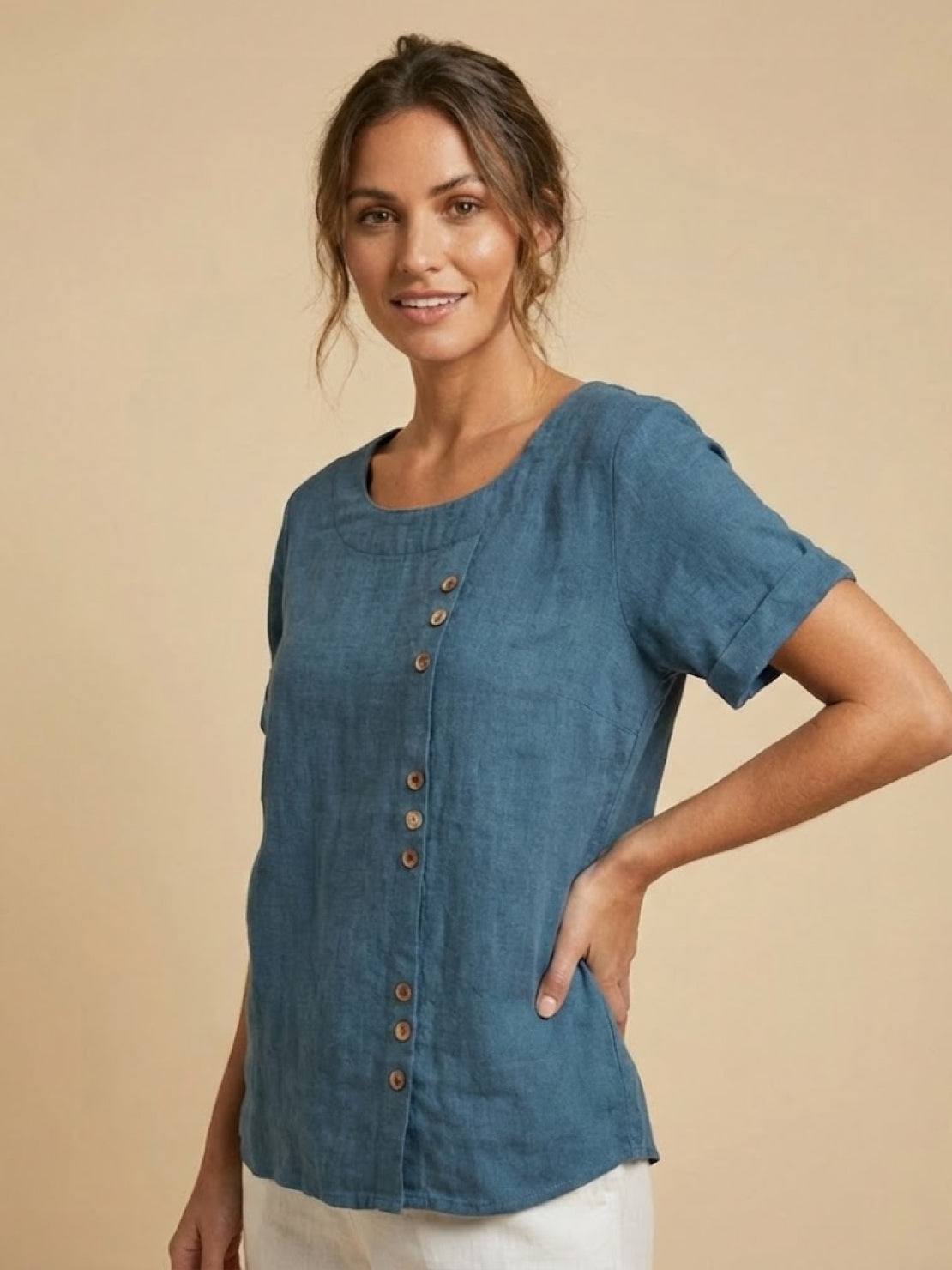 Women’s round neck blouse with button detailing and a relaxed fit, suitable for summer outfits, casual wear, and everyday styling.