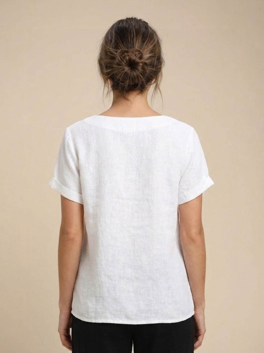 Women’s round neck blouse with button detailing and a relaxed fit, suitable for summer outfits, casual wear, and everyday styling.