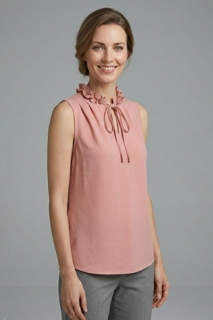Women’s sleeveless top with ruffle V-neckline, button detail, and wide shoulders, suitable for casual wear and office outfits.