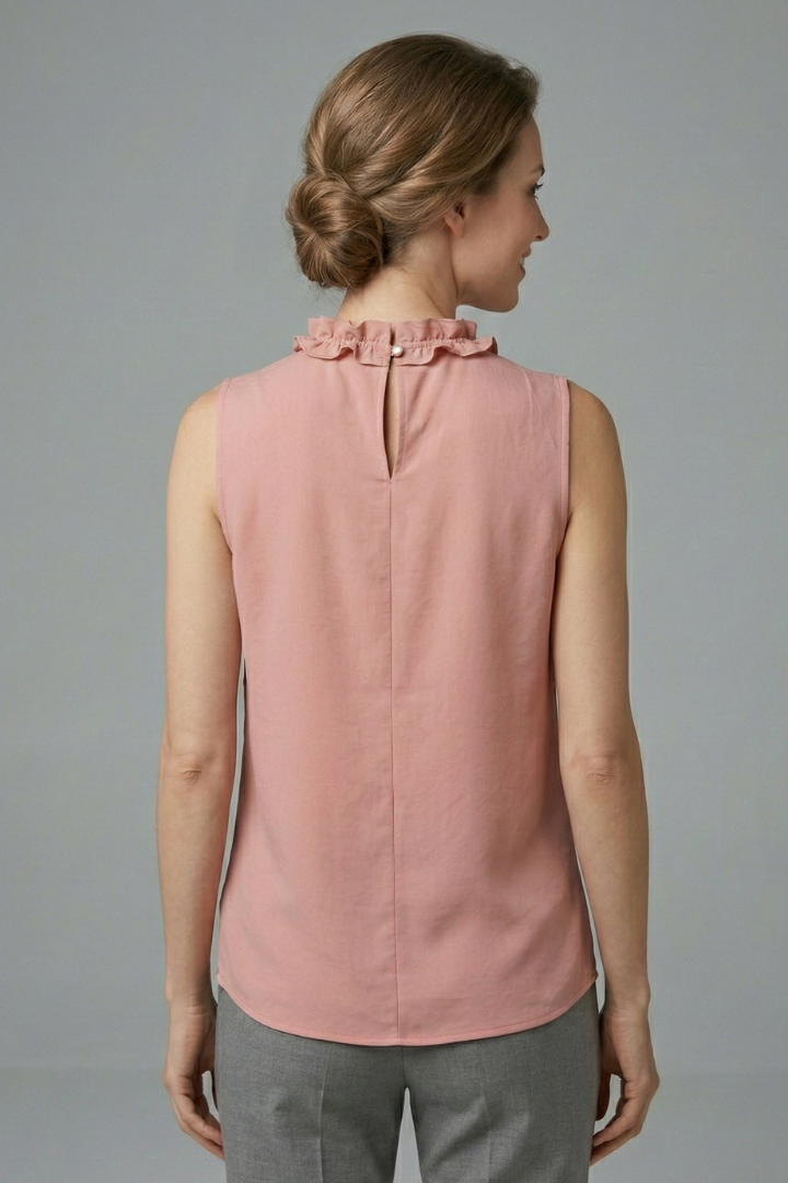 Women’s sleeveless top with ruffle V-neckline, button detail, and wide shoulders, suitable for casual wear and office outfits.
