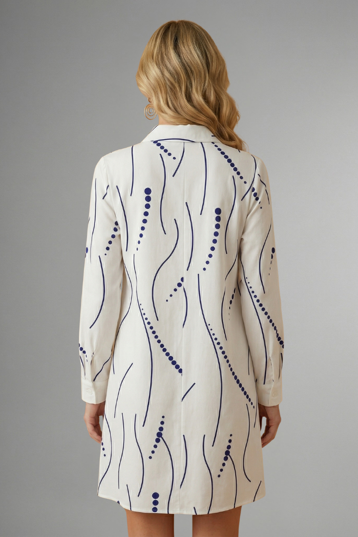 Women’s shirt dress with lapel collar, button-front closure, long sleeves, and wavy patterned surface for casual everyday styling.