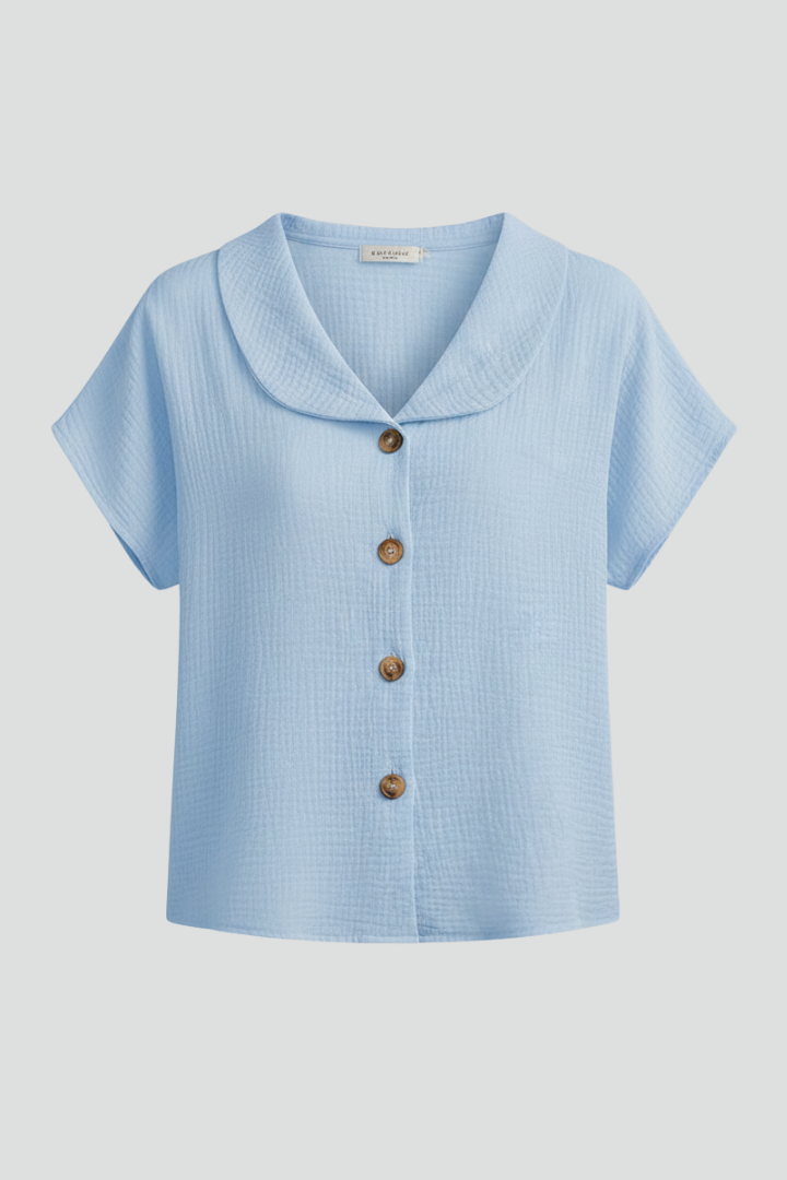 Women’s short sleeve top with V-neckline, front button detail, and textured surface, suitable for casual wear and everyday styling.