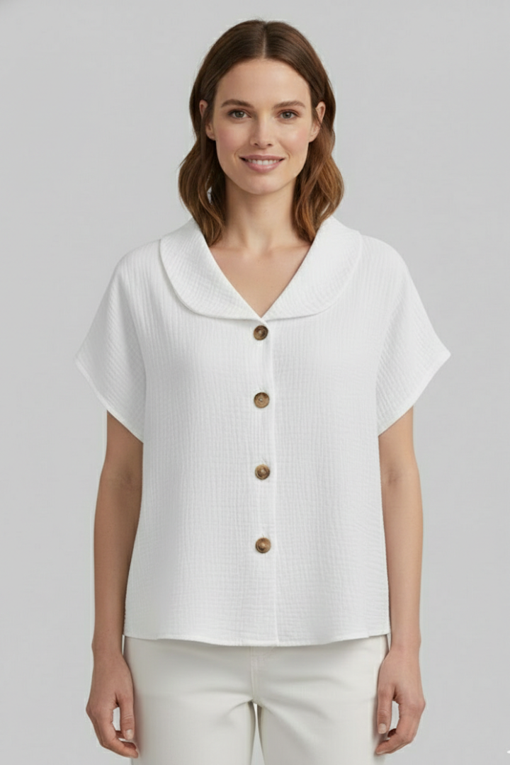 Women’s short sleeve top with V-neckline, front button detail, and textured surface, suitable for casual wear and everyday styling.