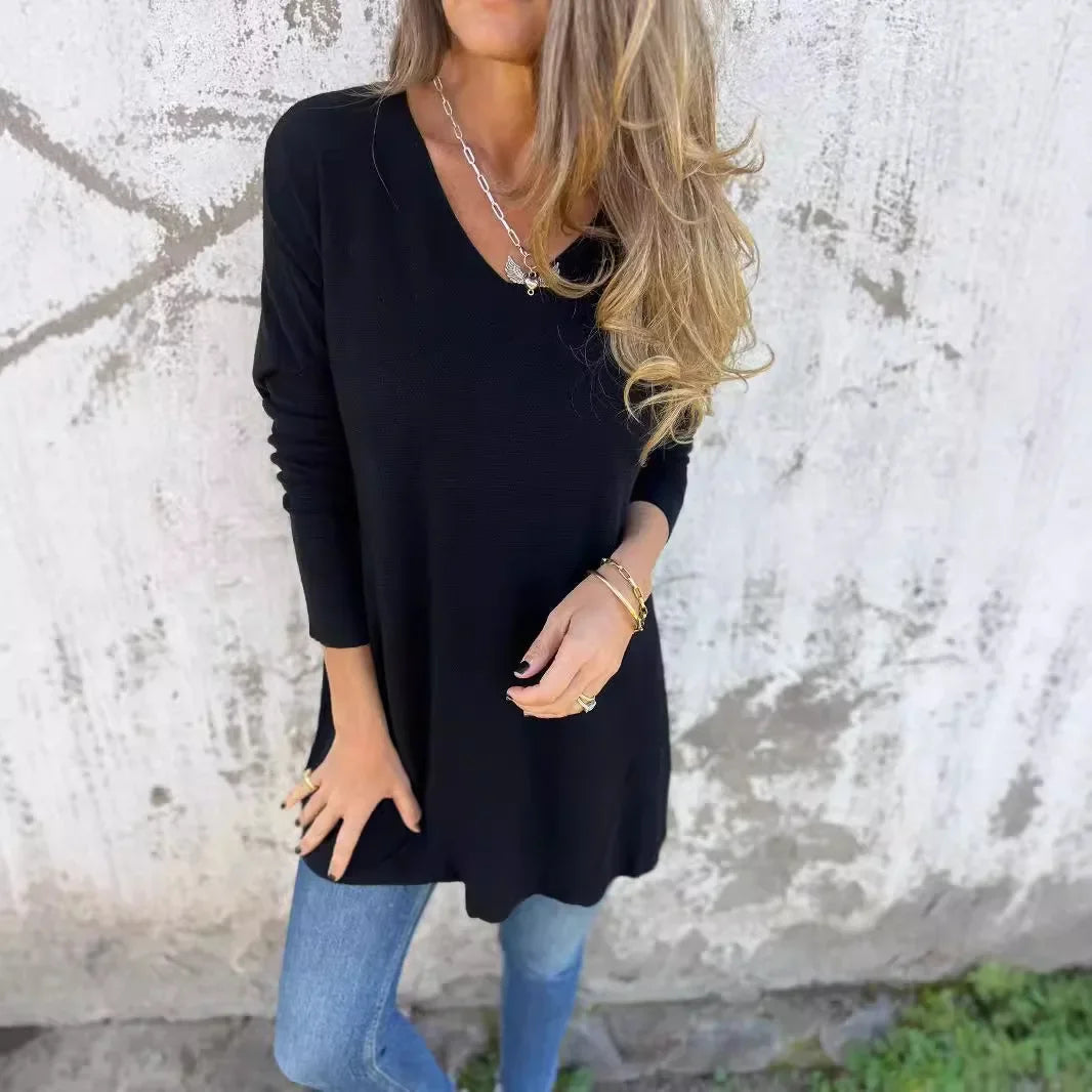 Women’s tunic top with V-neckline, longline length, and relaxed oversized fit, suitable for casual wear, layering, and everyday styling.