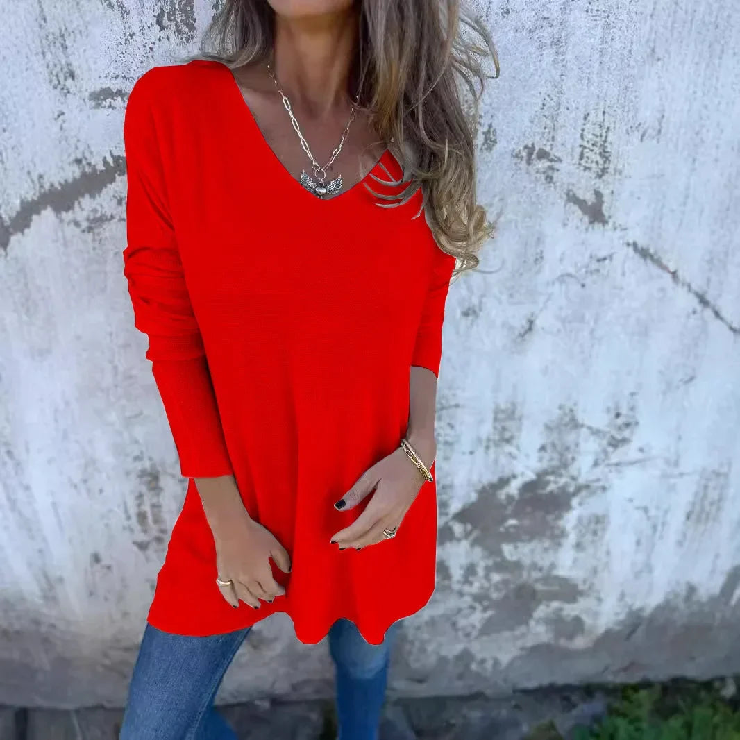 Women’s tunic top with V-neckline, longline length, and relaxed oversized fit, suitable for casual wear, layering, and everyday styling.