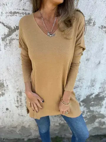 Women’s tunic top with V-neckline, longline length, and relaxed oversized fit, suitable for casual wear, layering, and everyday styling.