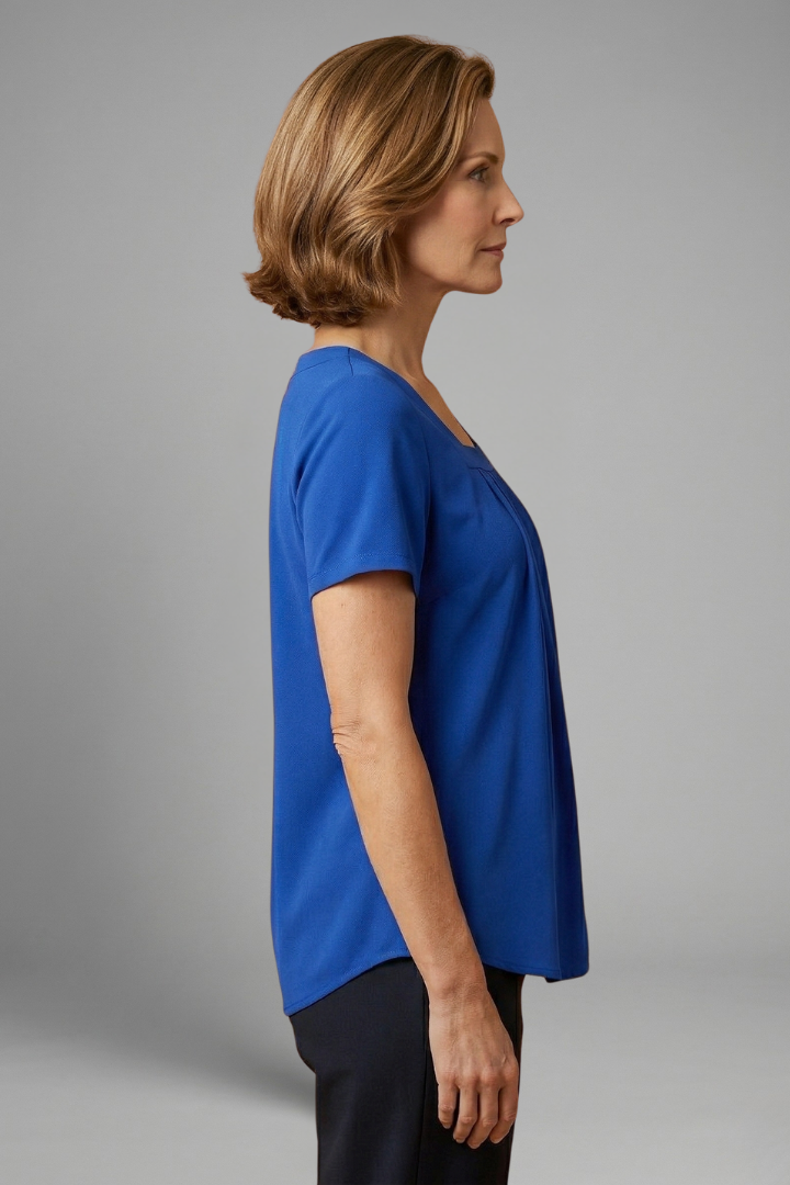 Women’s tunic top with square neckline, pleated front detail, loose fit, and hip-length hem for casual everyday styling.