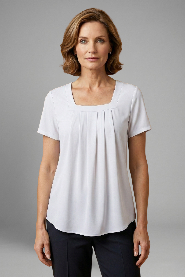 Women’s tunic top with square neckline, pleated front detail, loose fit, and hip-length hem for casual everyday styling.