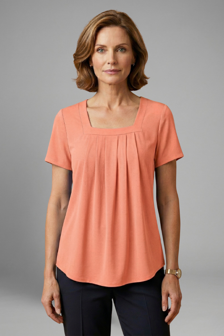 Women’s tunic top with square neckline, pleated front detail, loose fit, and hip-length hem for casual everyday styling.