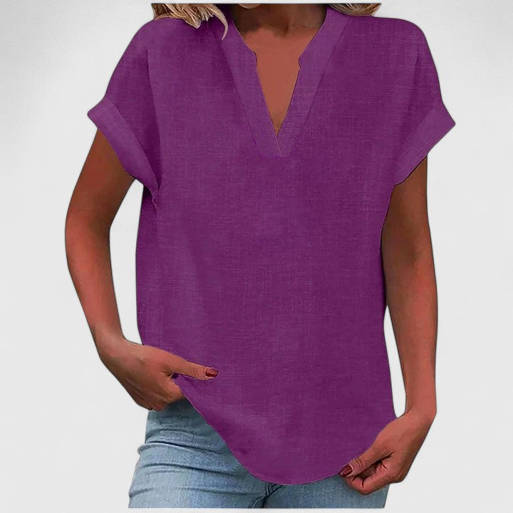 Women’s V-neck blouse with rolled short sleeves and relaxed fit, ideal for smart-casual outfits and everyday styling.