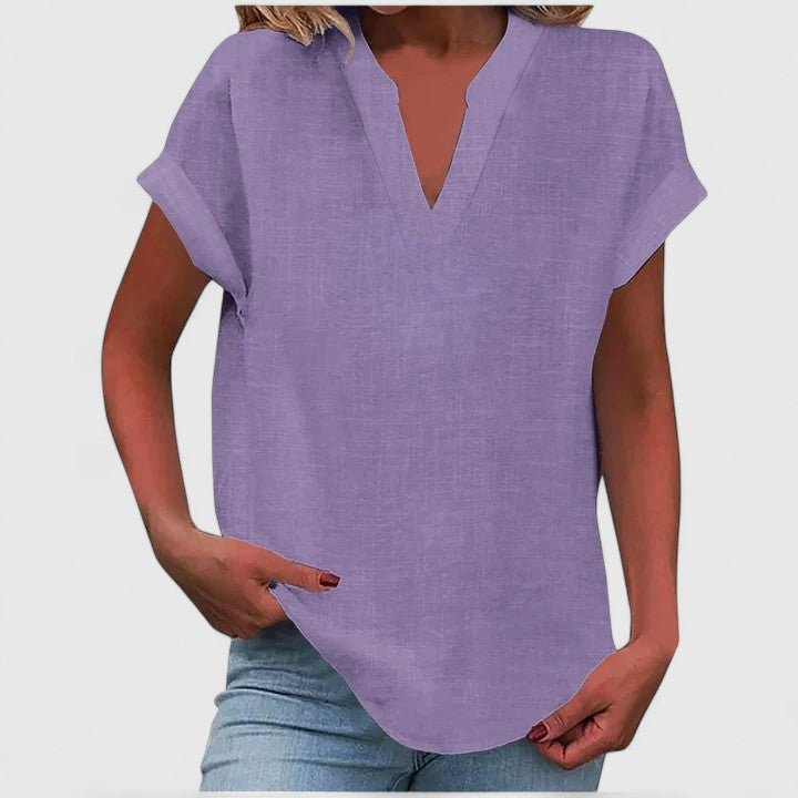 Women’s V-neck blouse with rolled short sleeves and relaxed fit, ideal for smart-casual outfits and everyday styling.