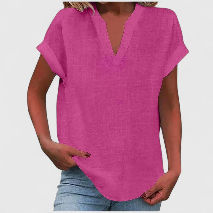 Women’s V-neck blouse with rolled short sleeves and relaxed fit, ideal for smart-casual outfits and everyday styling.