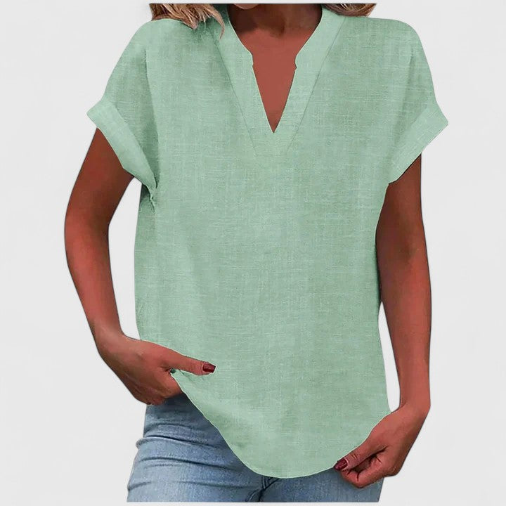 Women’s V-neck blouse with rolled short sleeves and relaxed fit, ideal for smart-casual outfits and everyday styling.