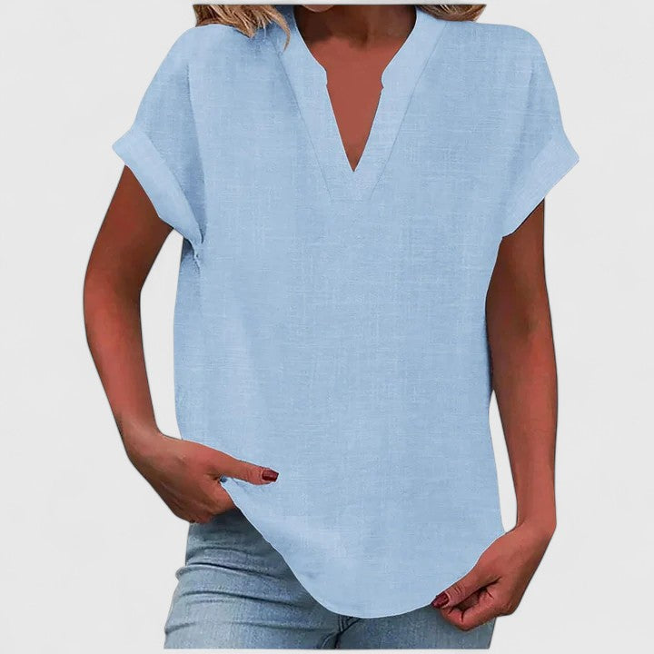 Women’s V-neck blouse with rolled short sleeves and relaxed fit, ideal for smart-casual outfits and everyday styling.