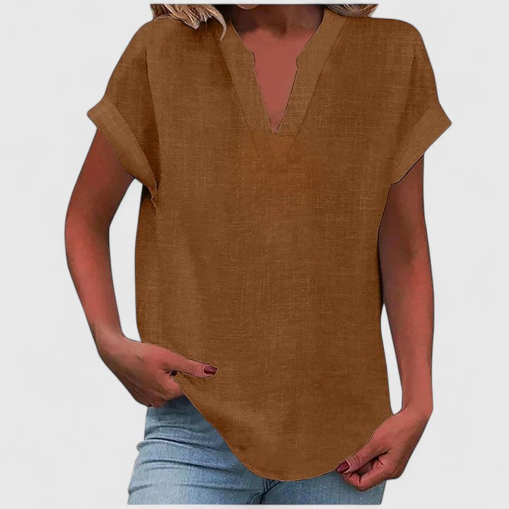 Women’s V-neck blouse with rolled short sleeves and relaxed fit, ideal for smart-casual outfits and everyday styling.