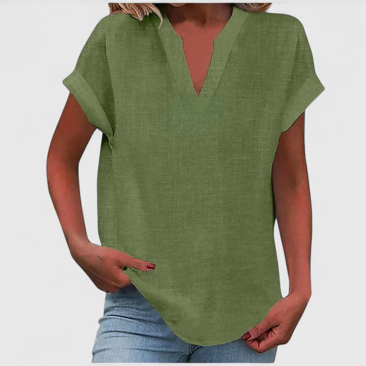 Women’s V-neck blouse with rolled short sleeves and relaxed fit, ideal for smart-casual outfits and everyday styling.