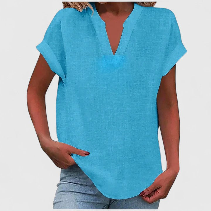Women’s V-neck blouse with rolled short sleeves and relaxed fit, ideal for smart-casual outfits and everyday styling.