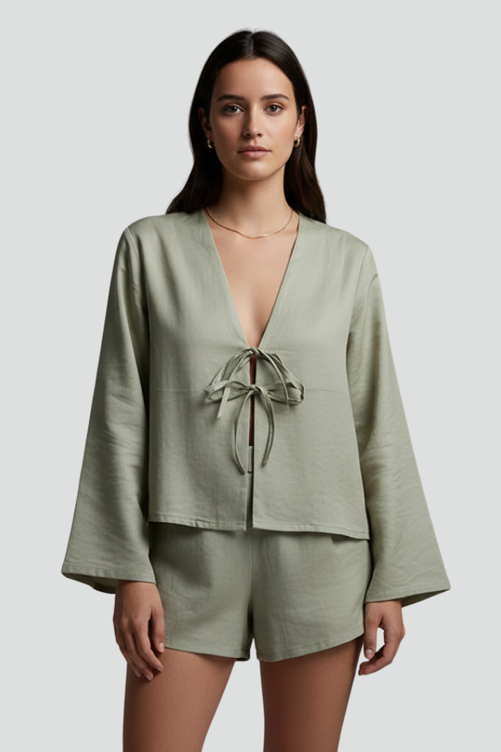 Women’s blouse with deep V-neckline and lace-up tie closure, featuring long sleeves and a relaxed fit for everyday and casual wear
