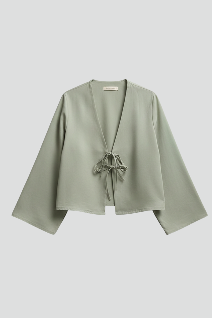 Women’s blouse with deep V-neckline and lace-up tie closure, featuring long sleeves and a relaxed fit for everyday and casual wear