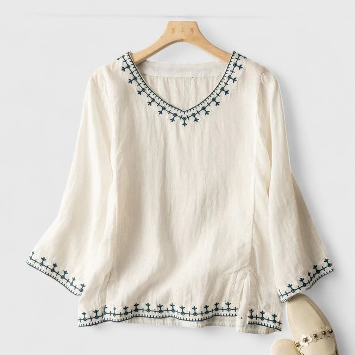 Women’s v-neck blouse with embroidered detailing and a relaxed fit, suitable for office outfits, casual wear, and smart occasions.