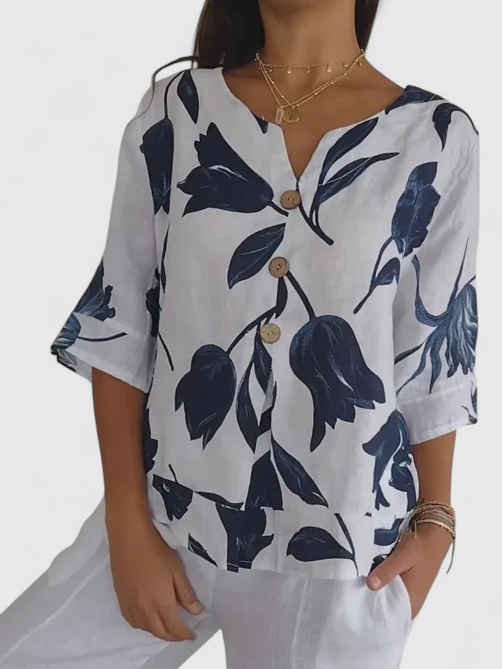 Women’s v-neck blouse with a floral print and relaxed fit, suitable for casual outfits, office wear, and evening occasions.