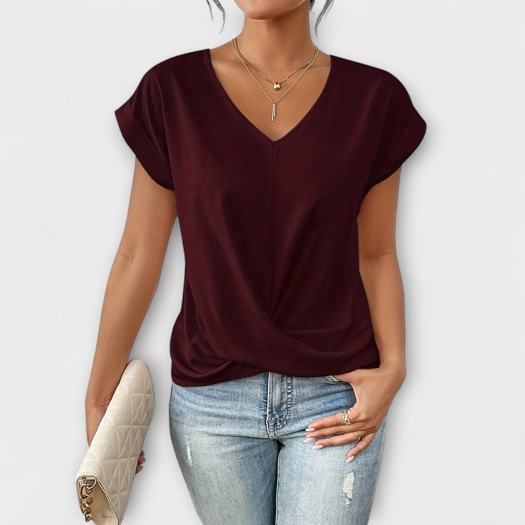 Women’s V-neck top with button detail and a flattering fit, ideal for office wear, casual outings, and smart-casual styling.