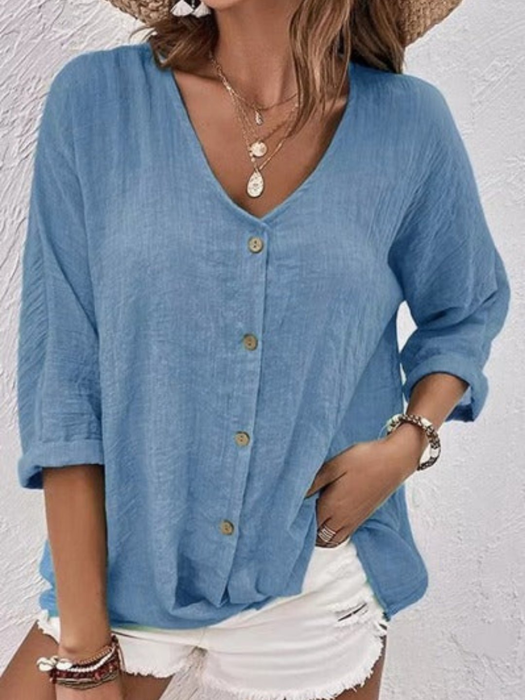 Women’s V-neck top with button-front closure and three-quarter sleeves, perfect for casual wear, travel, and warm-weather styling.