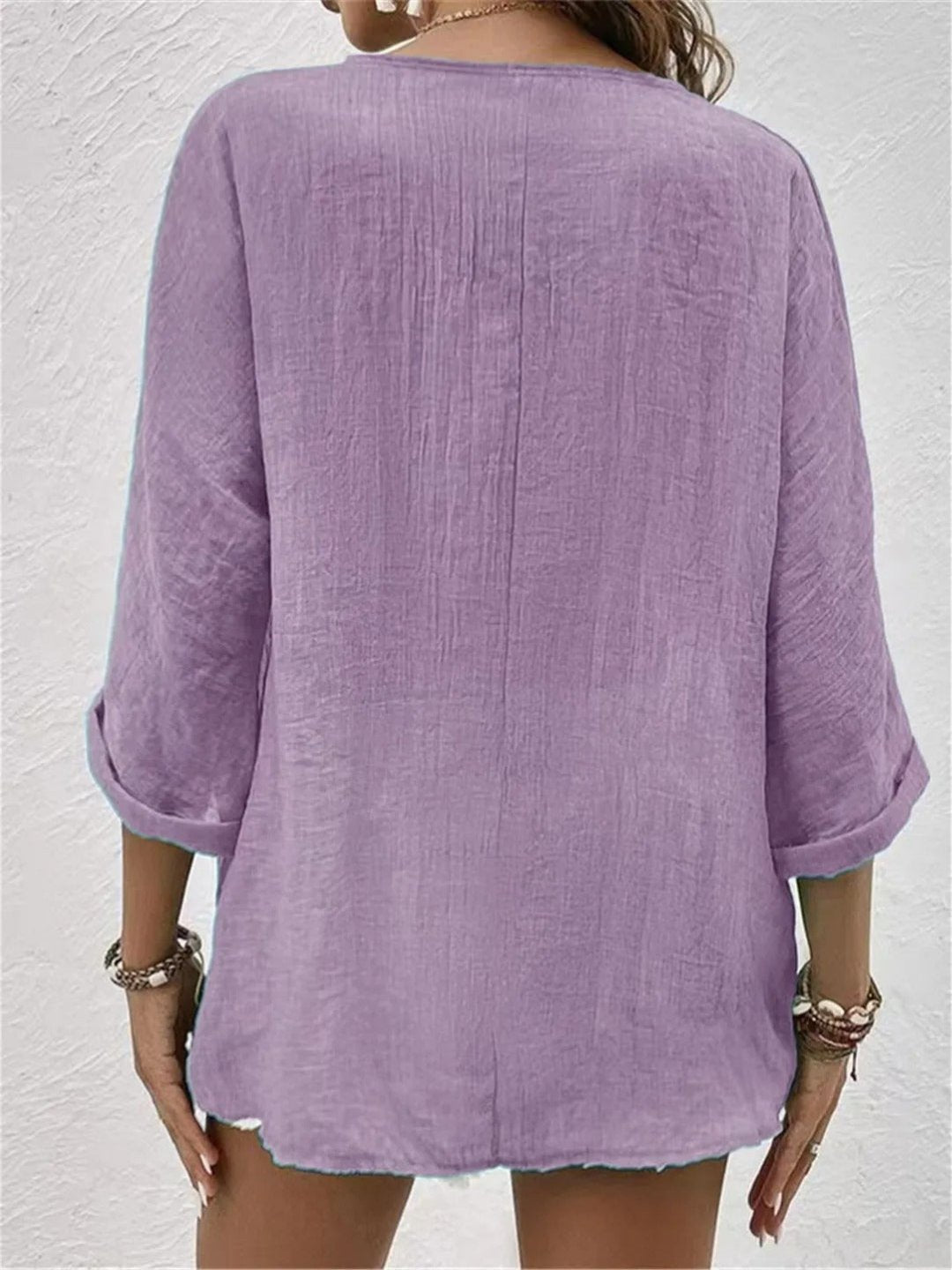 Women’s V-neck top with button-front closure and three-quarter sleeves, perfect for casual wear, travel, and warm-weather styling.
