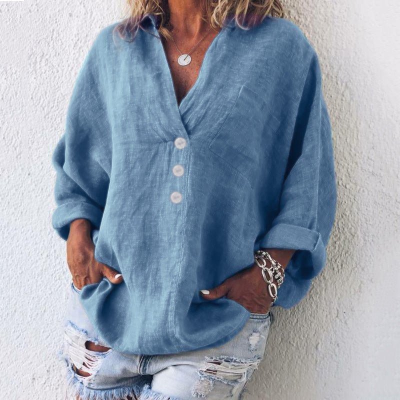 Women’s blouse with V-neckline, roll-tab sleeves, button-front closure, and relaxed oversized fit, suitable for office wear and everyday styling.