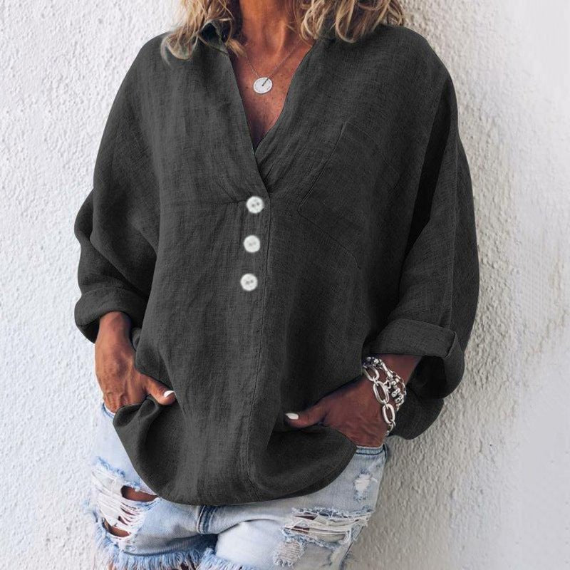 Women’s blouse with V-neckline, roll-tab sleeves, button-front closure, and relaxed oversized fit, suitable for office wear and everyday styling.