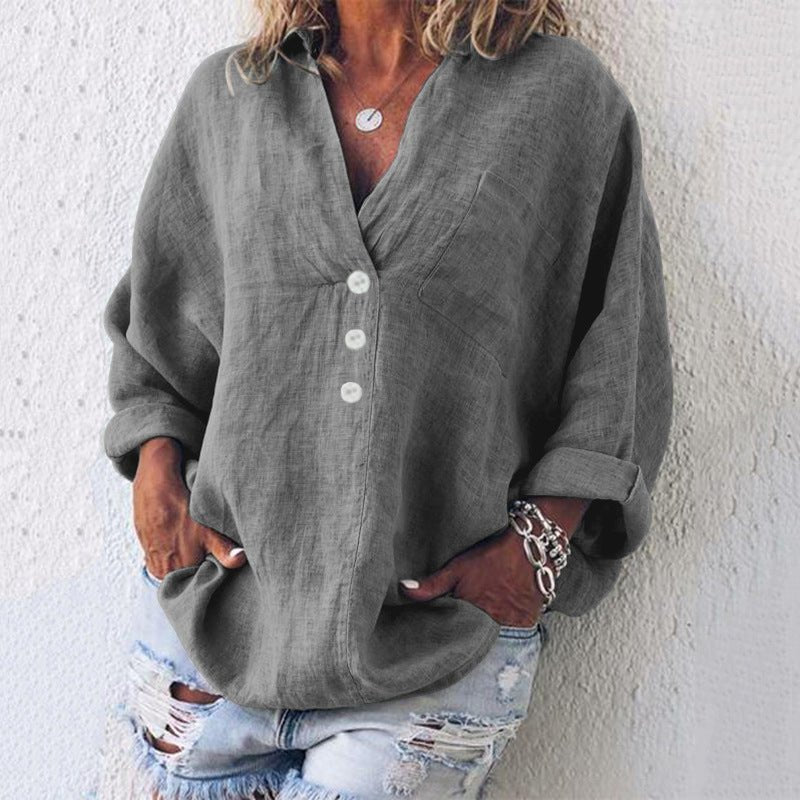 Women’s blouse with V-neckline, roll-tab sleeves, button-front closure, and relaxed oversized fit, suitable for office wear and everyday styling.
