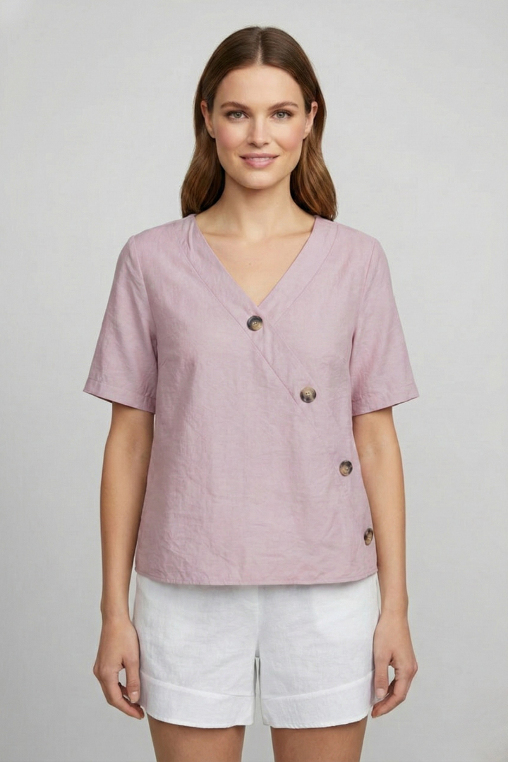 Women’s wrap style blouse with V-neckline and button accents, featuring short sleeves and a straight hem for office or everyday wear.