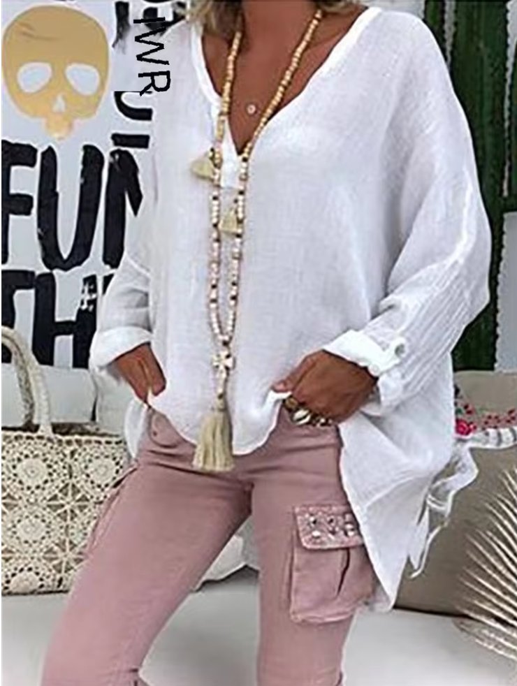Plus size women’s blouse with V-neckline, roll-tab sleeves, relaxed fit, and curved hem, suitable for work, travel, and everyday wear.