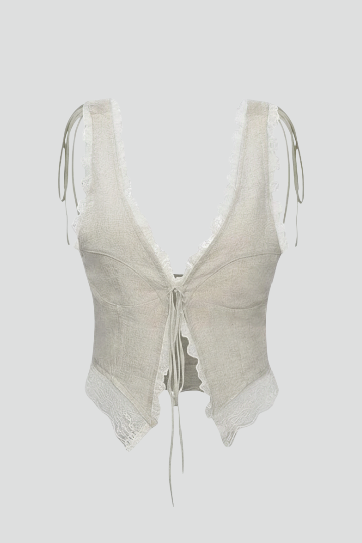 Women’s sleeveless top with deep V-neckline, tie-front fastening, asymmetrical hem, and textured surface, suitable for summer and casual outfits.