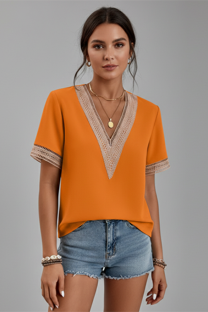 Women’s V-neck blouse with decorative trim, short sleeves, and straight fit, suitable for everyday wear and office outfits.