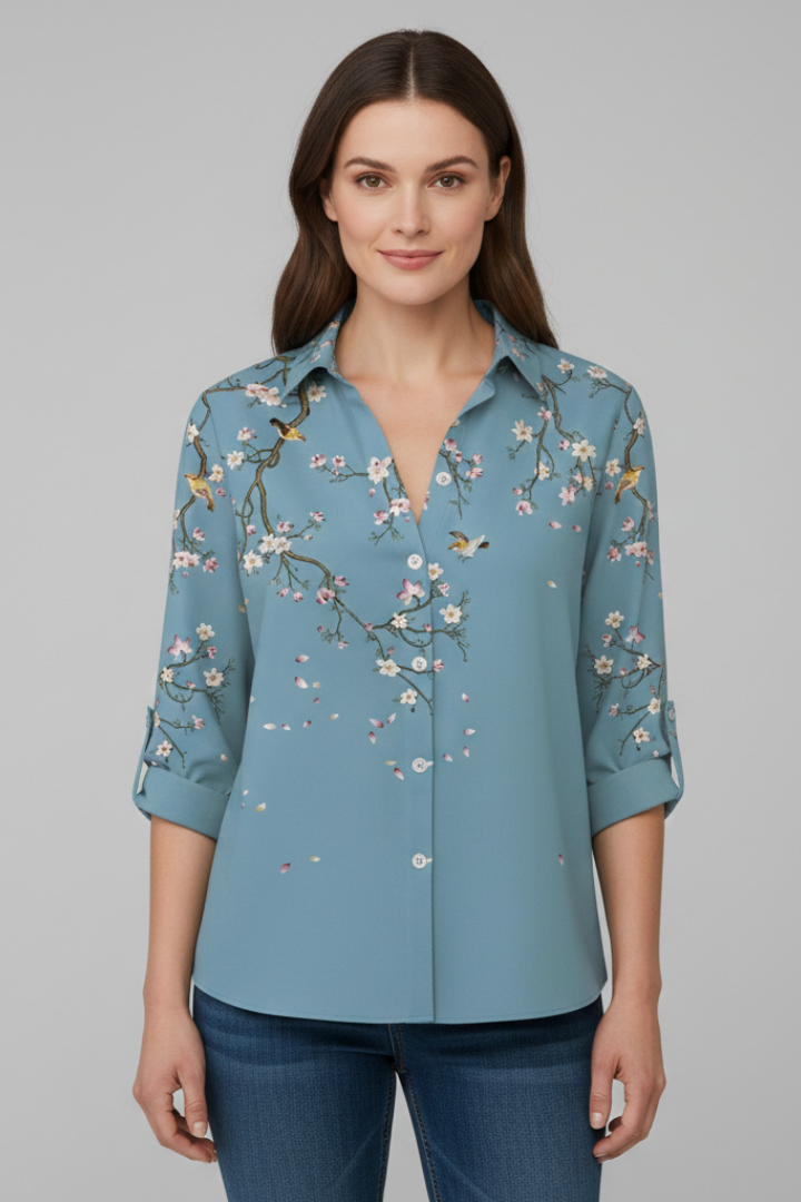 Women’s blouse with collared neckline and floral print, featuring long sleeves and button closure for everyday and work styling.