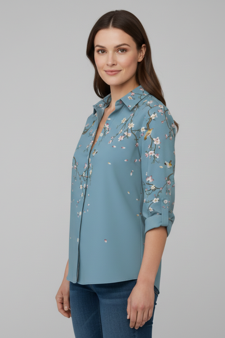 Women’s blouse with collared neckline and floral print, featuring long sleeves and button closure for everyday and work styling.