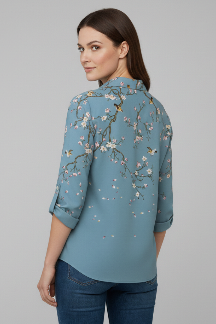 Women’s blouse with collared neckline and floral print, featuring long sleeves and button closure for everyday and work styling.