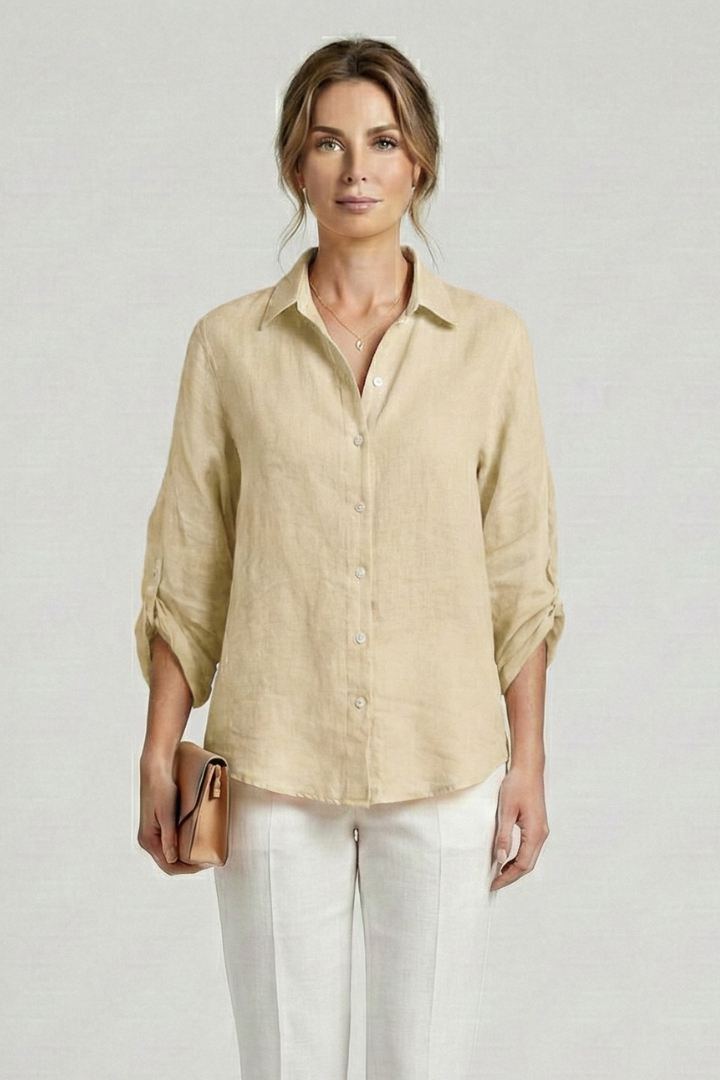 Women’s collared blouse with button fastening and roll-up sleeves, featuring a curved hem for everyday and work styling.